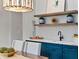 Dining area with blue cabinetry, floating shelves, and views of the backyard at 660 Timm Valley Ne Rd, Atlanta, GA 30305