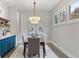 Elegant dining room with a bar area, hardwood floors, three-light pendant and natural lighting at 660 Timm Valley Ne Rd, Atlanta, GA 30305