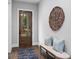 Entryway with a wooden door, hardwood floors, and a decorative wicker circle wall decoration at 660 Timm Valley Ne Rd, Atlanta, GA 30305