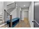 Welcoming entryway with a blue bench and storage cubbies below the staircase with beautiful hardwood floors at 660 Timm Valley Ne Rd, Atlanta, GA 30305