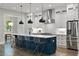 Bright kitchen with a navy center island with seating, stainless steel appliances, and pendant lighting at 660 Timm Valley Ne Rd, Atlanta, GA 30305