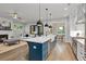 Open floor plan with a kitchen island flowing into the living room with a fireplace and hardwood floors at 660 Timm Valley Ne Rd, Atlanta, GA 30305