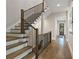 Elegant staircase with wood and wrought iron detailing, leading to upper floors at 660 Timm Valley Ne Rd, Atlanta, GA 30305