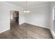 Bright dining room featuring hardwood floors and a view into the kitchen at 5132 Silhouette Sw Ln, Mableton, GA 30126