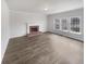 Bright living room featuring a brick fireplace, large windows and a hardwood floor at 5132 Silhouette Sw Ln, Mableton, GA 30126