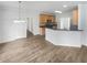 Bright, open-concept space featuring hardwood floors, stainless steel appliances, and a breakfast bar at 5132 Silhouette Sw Ln, Mableton, GA 30126