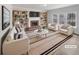 Bright living room featuring a brick fireplace, built-in bookshelves, and large windows at 5132 Silhouette Sw Ln, Mableton, GA 30126