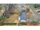 A high angle view of the home highlighting the deck, roof, and surrounding greenery at 334 Nancy Sw Ct, Lilburn, GA 30047