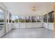 Spacious sunroom featuring a ceiling fan and a large window view at 334 Nancy Sw Ct, Lilburn, GA 30047