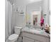 Bathroom featuring a shower, a toilet, and a vanity with granite countertops and a decorative mirror at 3374 Grey St, Duluth, GA 30096