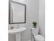 Stylish half-bathroom with modern fixtures and a pedestal sink at 3374 Grey St, Duluth, GA 30096