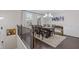 Open-concept dining room with modern chandelier and hardwood floors at 3374 Grey St, Duluth, GA 30096