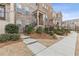 Well-maintained townhome with brick exterior, inviting entry, and neat landscaping at 3374 Grey St, Duluth, GA 30096