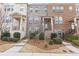Charming townhome with brick facade, manicured landscaping, and inviting front entry at 3374 Grey St, Duluth, GA 30096