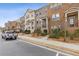 Row of brick townhomes with inviting entries and well-maintained landscaping at 3374 Grey St, Duluth, GA 30096
