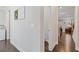 Bright hallway with hardwood floors leading to kitchen and living areas at 3374 Grey St, Duluth, GA 30096