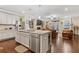 Beautiful kitchen with a granite island and stainless steel appliances, flowing into the living area at 3374 Grey St, Duluth, GA 30096