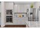 Bright kitchen featuring stainless steel appliances, double ovens, and modern gray cabinetry at 3374 Grey St, Duluth, GA 30096