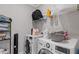 A functional laundry room featuring modern washer and dryer, a shelf, and organized storage space at 3374 Grey St, Duluth, GA 30096