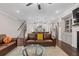 Expansive living room with hardwood floors, seamless connection to a modern kitchen and stairway at 3374 Grey St, Duluth, GA 30096