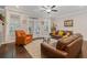Cozy living room boasting hardwood floors, a ceiling fan, and direct access to outdoor amenities at 3374 Grey St, Duluth, GA 30096