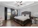 Spacious main bedroom with a decorative tray ceiling, dark wood floors, large windows and an oversized decorative headboard at 3374 Grey St, Duluth, GA 30096