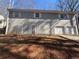 Exterior view of the back of a two-story home featuring two doors and a two-car garage at 5080 Springtree Ct, Lithonia, GA 30038