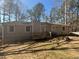 Back exterior of home with a wooden deck and spacious yard at 5080 Springtree Ct, Lithonia, GA 30038