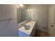 Bathroom featuring a double sink vanity, large mirror, and modern lighting at 5080 Springtree Ct, Lithonia, GA 30038