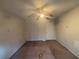 An empty bedroom featuring a ceiling fan and neutral walls at 5080 Springtree Ct, Lithonia, GA 30038