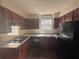 Kitchen with stainless steel sink and black appliances at 5080 Springtree Ct, Lithonia, GA 30038