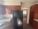 Kitchen with granite counter tops, custom cabinets, and black refrigerator at 5080 Springtree Ct, Lithonia, GA 30038