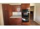 Kitchen featuring custom cabinets and black double ovens at 5080 Springtree Ct, Lithonia, GA 30038