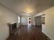 Open-concept living room featuring brick fireplace and wood flooring at 5080 Springtree Ct, Lithonia, GA 30038