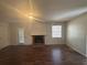 Living room featuring a brick fireplace, wood floors, and natural light at 5080 Springtree Ct, Lithonia, GA 30038