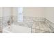 Bathroom featuring tiled tub surround and gray toned countertops at 428 Rainey Rd, Temple, GA 30179