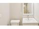 Bathroom featuring white vanity with a white basin sink and commode at 428 Rainey Rd, Temple, GA 30179