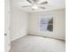 Bedroom featuring neutral carpet, white walls, ceiling fan, and a large window at 428 Rainey Rd, Temple, GA 30179