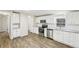 Bright kitchen featuring stainless steel appliances, white subway tile backsplash, and gray toned wood floors at 428 Rainey Rd, Temple, GA 30179