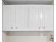 Close up of the white upper cabinets in the laundry room at 428 Rainey Rd, Temple, GA 30179