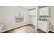 Bright laundry room with upper cabinets, sink, and granite countertop at 428 Rainey Rd, Temple, GA 30179