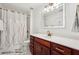 Beautiful bathroom features a modern vanity, illuminated mirror and luxurious marble flooring at 4450 Sandalwood Way, Cumming, GA 30041