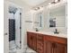 This elegant bathroom features double sinks, illuminated mirrors, and modern marble floors at 4450 Sandalwood Way, Cumming, GA 30041