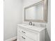 Elegant bathroom vanity with marble countertop and modern faucet, complemented by a large mirror, offers a stylish and functional space at 4450 Sandalwood Way, Cumming, GA 30041