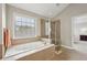 Bright bathroom featuring a tub with tile and a frameless glass shower at 4450 Sandalwood Way, Cumming, GA 30041