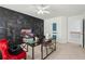 This bedroom features a chalkboard accent wall, modern desk, and cozy seating area at 4450 Sandalwood Way, Cumming, GA 30041