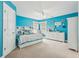 Bright bedroom with blue walls, ceiling fan, and built-in storage at 4450 Sandalwood Way, Cumming, GA 30041