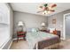 Inviting bedroom featuring a ceiling fan, bedside lamps, and a window with blinds at 4450 Sandalwood Way, Cumming, GA 30041