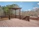 View of the wooden deck, wooden rails and pergola, and a pleasant landscape in the distance at 4450 Sandalwood Way, Cumming, GA 30041