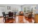 Bright dining area featuring hardwood floors, a dining table with chairs, and a door to the outside at 4450 Sandalwood Way, Cumming, GA 30041